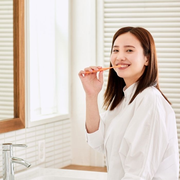 Woman brushing her teeth